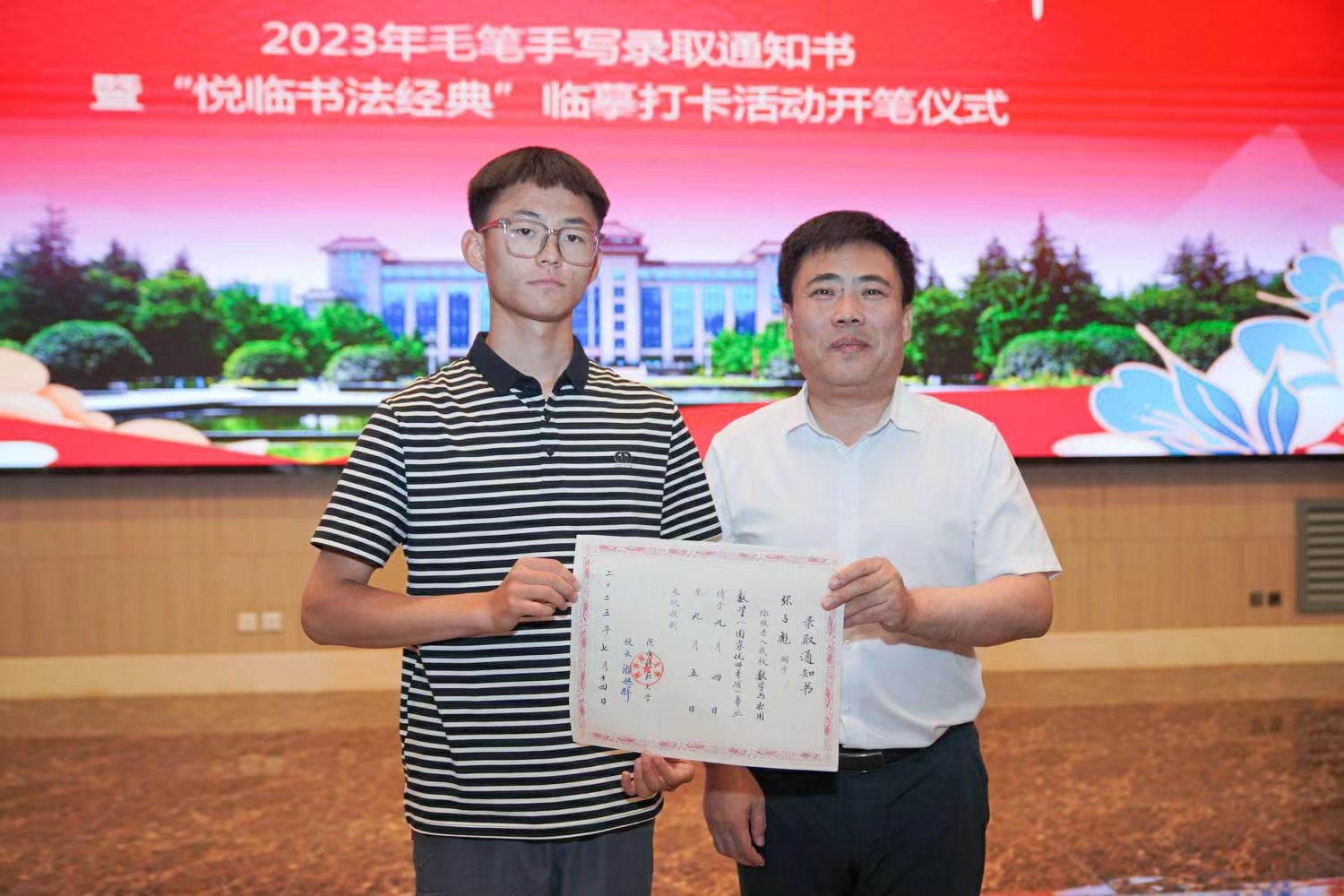 陜西師范大學(xué)黨委書記李忠軍為2023級新生代表張占彪同學(xué)發(fā)放錄取通知書。校方供圖