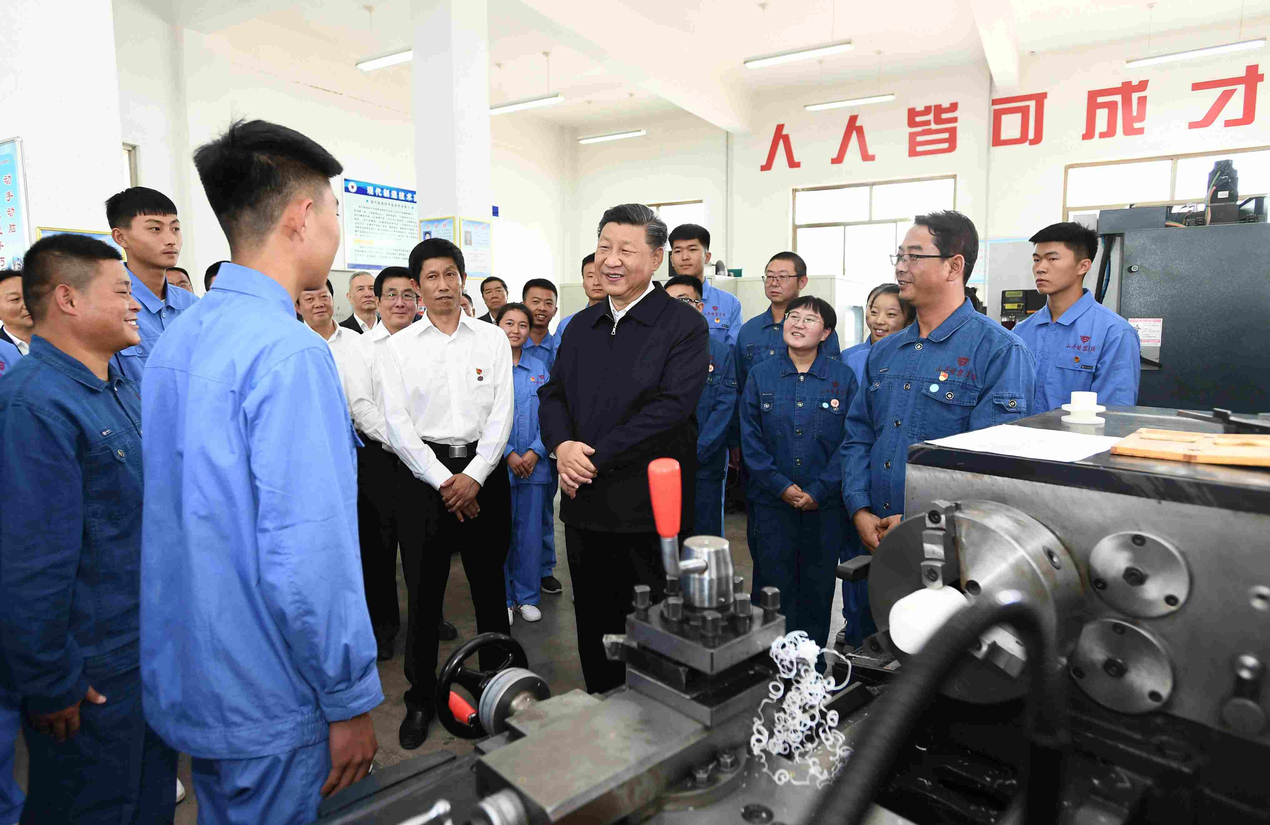 2019年8月20日，習(xí)近平在甘肅省張掖市山丹培黎學(xué)校現(xiàn)代制造技術(shù)實(shí)訓(xùn)室，觀看職業(yè)技能實(shí)訓(xùn)，同師生親切交流。