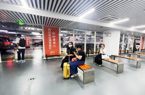 旅客在網(wǎng)約車空調(diào)等候區(qū)等候網(wǎng)約車。人民網(wǎng)記者 喬雪峰攝