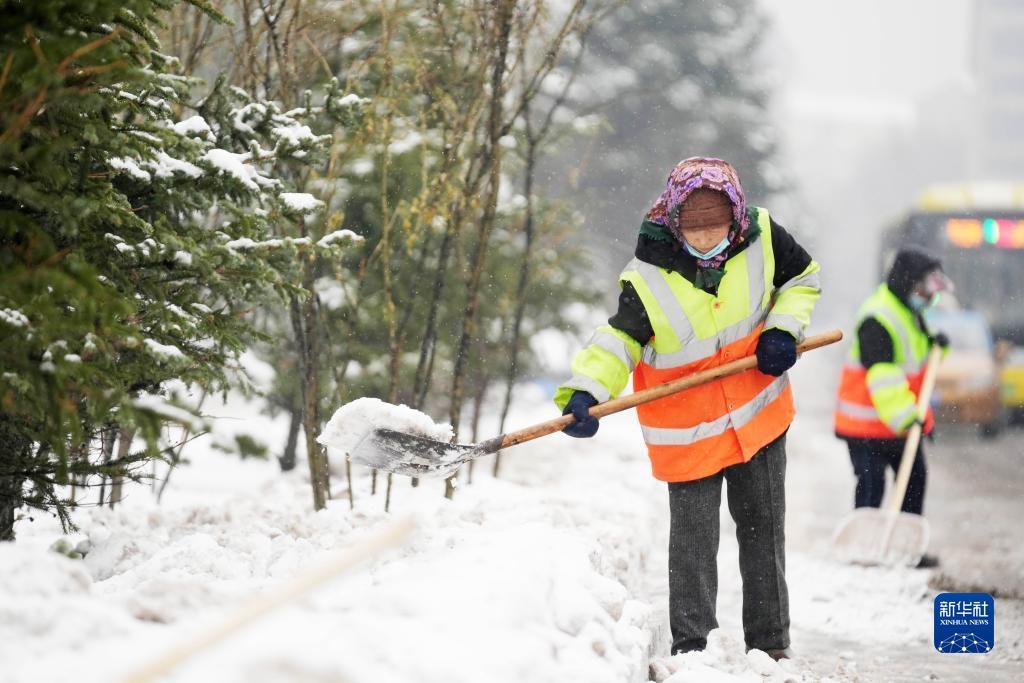 11月16日，環(huán)衛(wèi)工人在清理道路上的積雪。當日，黑龍江哈爾濱市迎來雨雪天氣。新華社記者 王建威 攝
