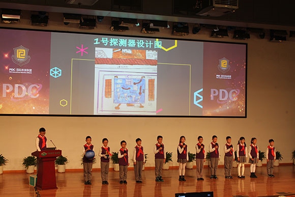 北京呼家樓中心小學(xué)的學(xué)生們展示PDC項(xiàng)目“新行星移民計(jì)劃探索衛(wèi)星設(shè)計(jì)”。