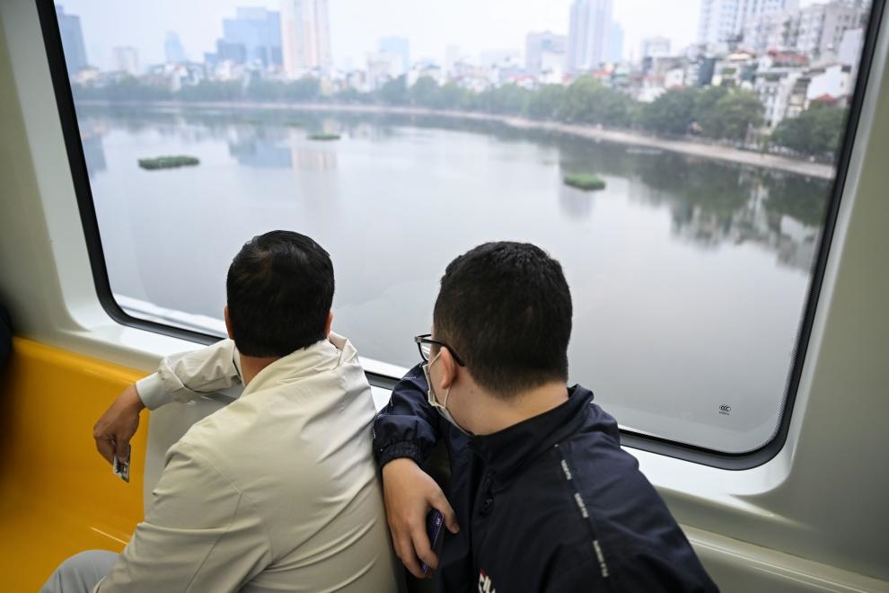 12月9日，市民在越南河內(nèi)輕軌二號線車廂內(nèi)透過車窗欣賞城市風(fēng)景。