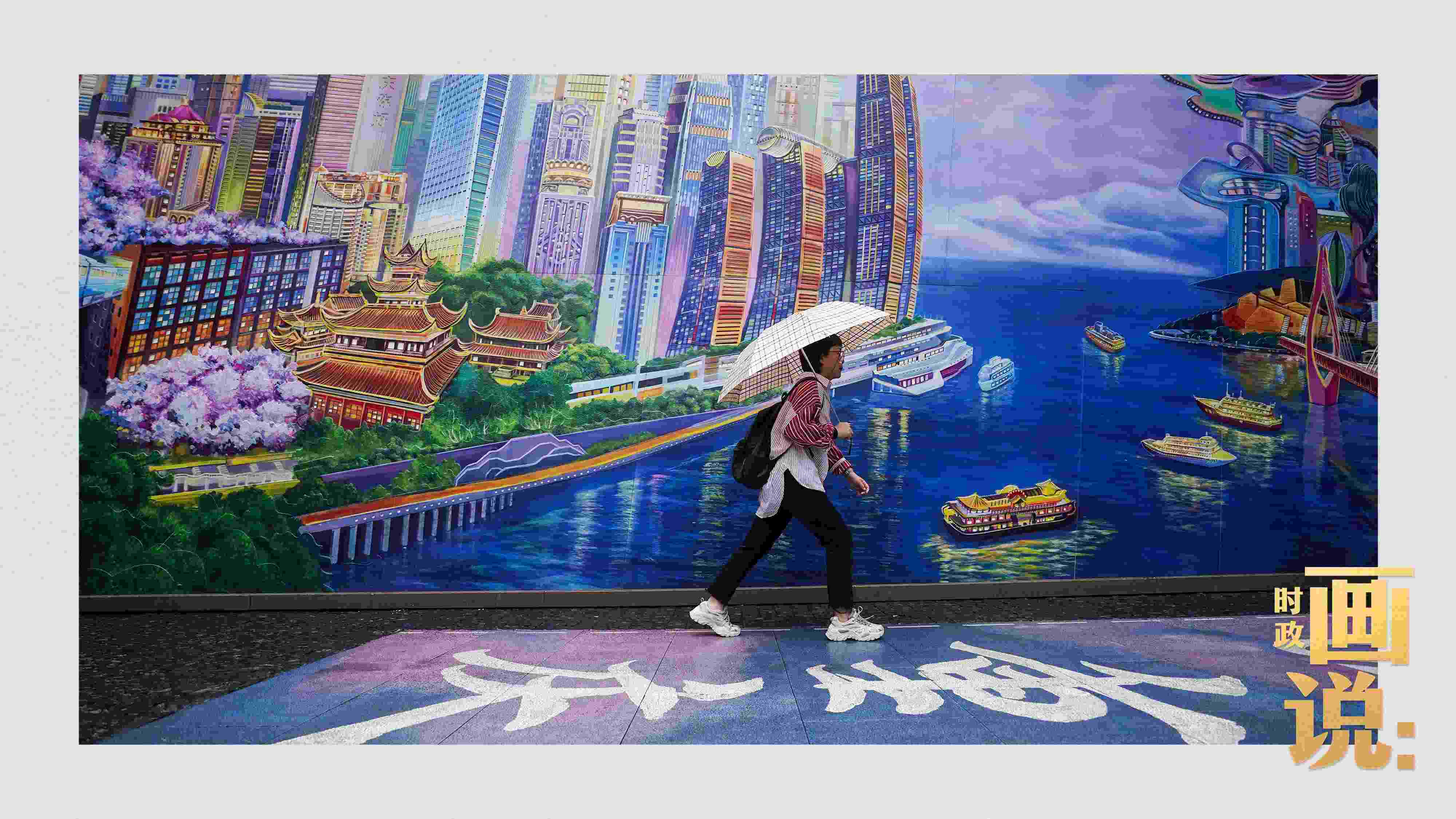 △小雨中，行人走過(guò)“重慶畫(huà)卷”主題壁畫(huà)。